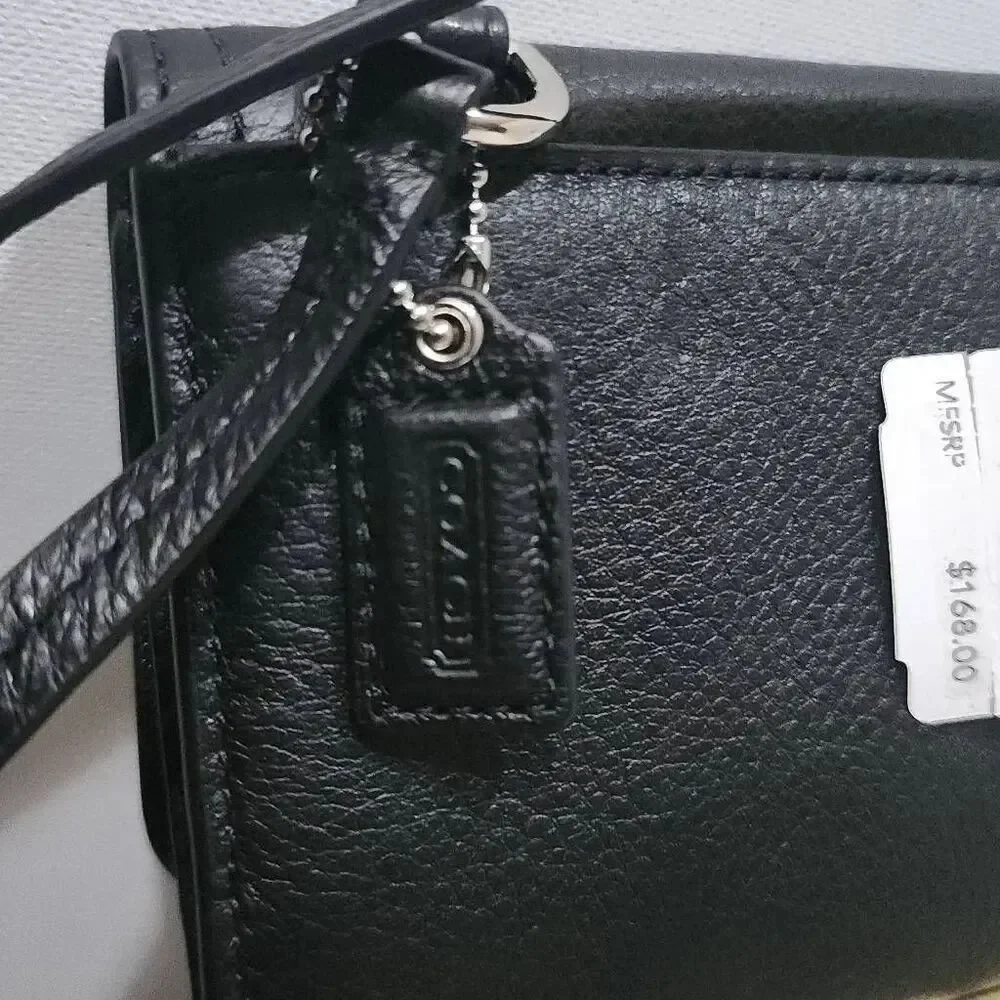 Coach Avery leather phone crossbody w/ a flap closure.